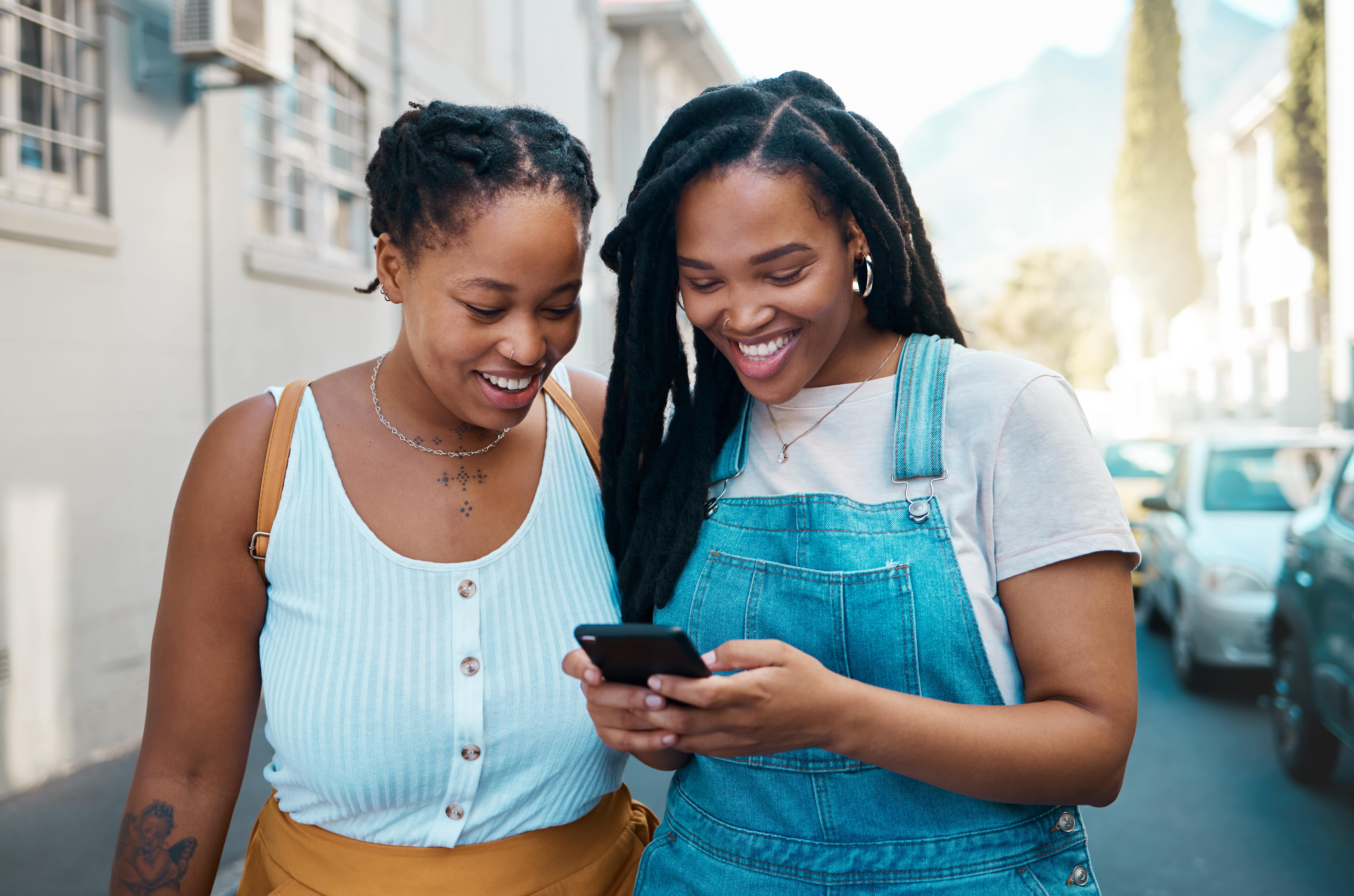 Two girls looking at their phone.